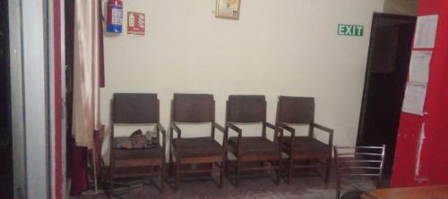 a group of chairs lined up against a wall at Super Royal Guest house in Jawālāpur