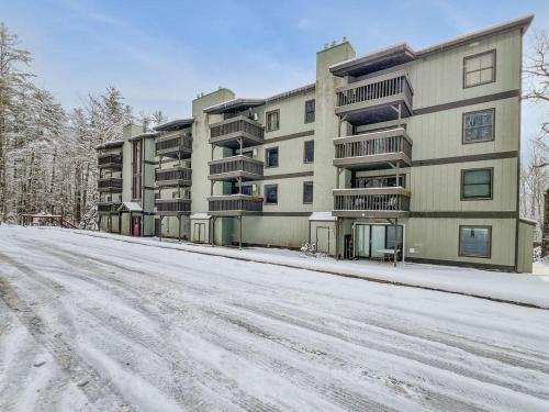 an empty snow covered street in front of a building at Gateway Condo A10 in Mendon