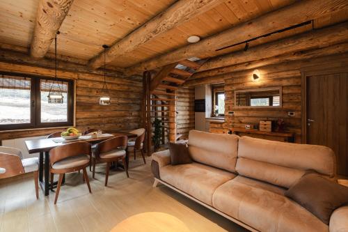 a living room with a couch and a table at Aurum Cabins in Zlatibor