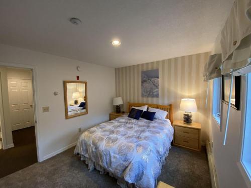 a bedroom with a large bed and a mirror at Pico Village Resort G301 in Killington