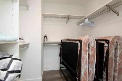 a room with three racks of clothes at Modern 3 Bedroom High-Rise with resort Pool in Los Angeles