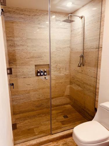 a bathroom with a shower with a toilet at Marina Corazón Sea View - Condo Puerto Cancún in Cancún