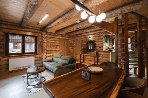 a living room with a table and a couch at Aurum Cabins in Zlatibor