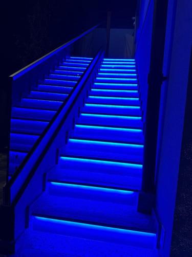 a blue staircase with blue lights on it at Apartament cu 2 Dormitoare de lux situat in complex ApartHotel Botosani 1 in Botoşani