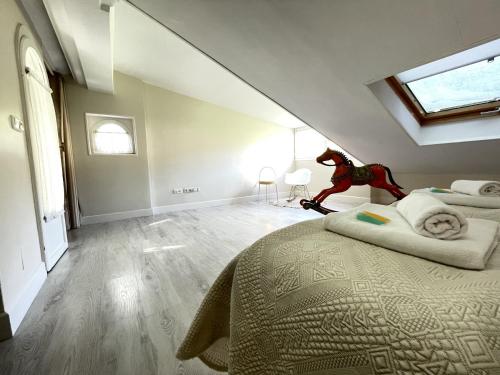 a bedroom with a bed with a dinosaur sitting on it at Loraitz by Smiling Rentals in Hondarribia