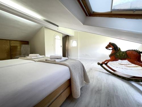 a bedroom with a bed with a wooden horse toy on the floor at Loraitz by Smiling Rentals in Hondarribia