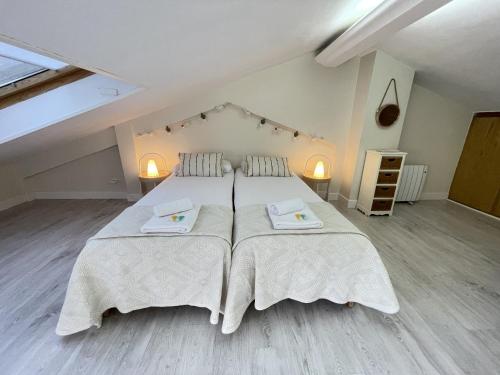 a large bedroom with two beds with white blankets at Loraitz by Smiling Rentals in Hondarribia