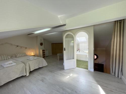 a large bedroom with a bed and a bathroom at Loraitz by Smiling Rentals in Hondarribia