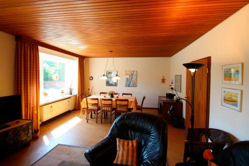 a living room with a table and a dining room at Ferienhof Ralf Becker Nr5 in Westfehmarn