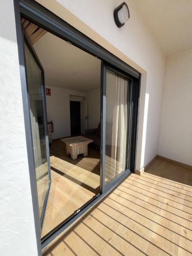 a sliding glass door of a room with a table at Via Caprasia Alojamiento Rural in Villargordo del Cabriel