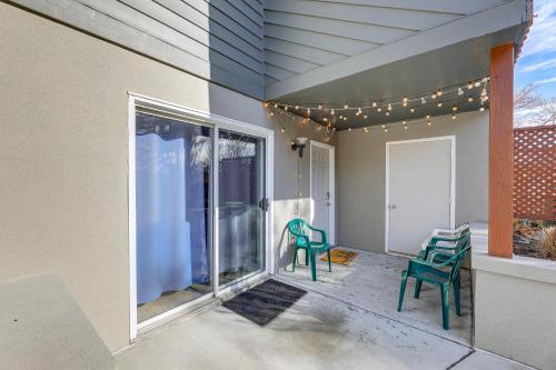 a patio with two green chairs and a window at 2 Mi to Rehoboth Beach Condo with Pool Access! in Rehoboth Beach