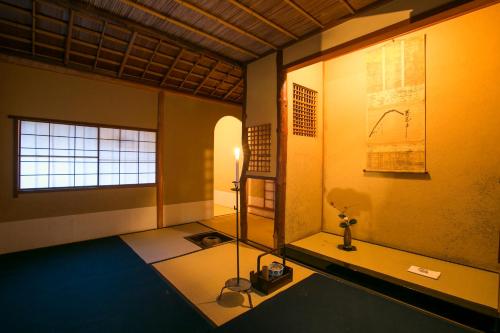 a room with a room with a table and a window at Gion Yoshiima in Kyoto