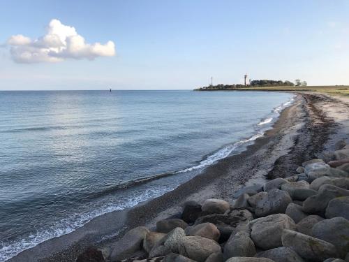 a beach with rocks and the water at Leuchttürmchen in Marienleuchte