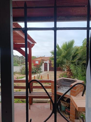 a view from a window of a patio with a bench at Cabaña Maggie in Guanaqueros