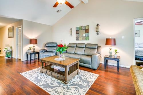 a living room with a couch and a table at Suburban Home in Magnolia with Fenced Yard in Magnolia