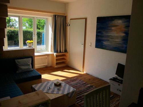 a living room with a couch and a table at Ferienhaus Schwille - Loft 2 in Westerbergen