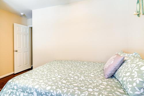 a bedroom with a bed with a pillow on it at Suburban Home in Magnolia with Fenced Yard in Magnolia