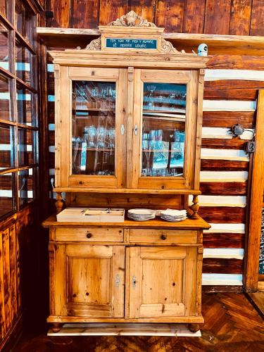a wooden cabinet with glass doors in a room at Horská Bouda v Obřím Dole in Pec pod Snezkou