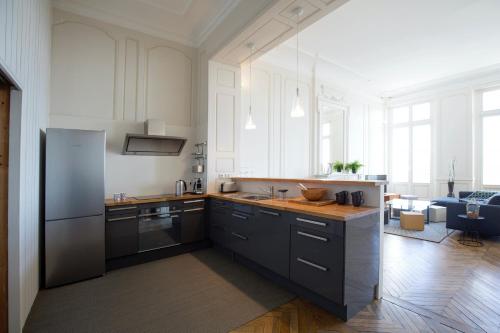 une cuisine avec un réfrigérateur et un plan de travail dans l'établissement Appartement sur les quais de Bordeaux, à Bordeaux