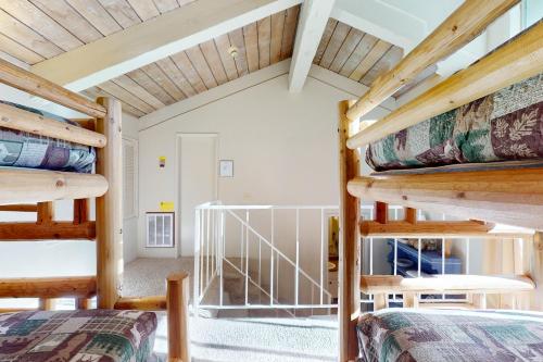 two bunk beds in a room with a staircase at Chamonix 100 in Mammoth Lakes