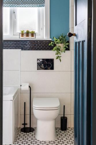 a bathroom with a white toilet and a window at The Kingsway in Ilkley