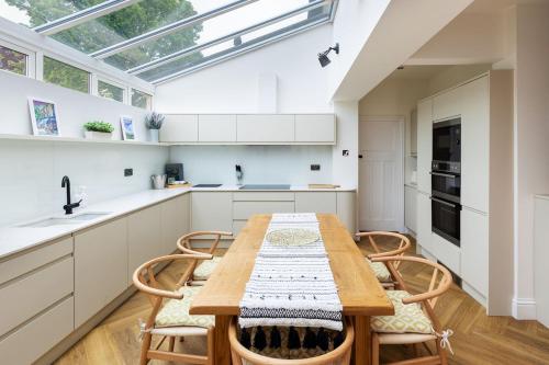 a kitchen with a wooden table and chairs at The Kingsway in Ilkley