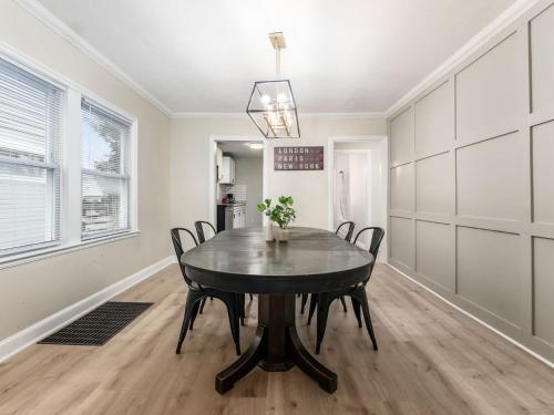 a dining room with a black table and chairs at Stay in the Palazzo in OSU! 10 BEDS! in Columbus