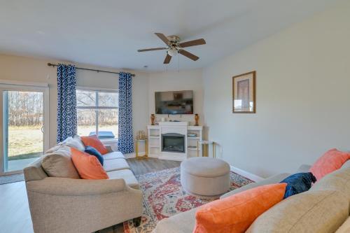 a living room with two couches and a ceiling fan at 6 Mi to PNC Music Pavilion Concord Townhome in Concord