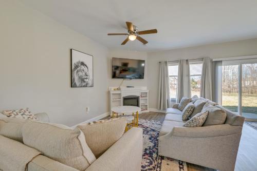 a living room with two couches and a fireplace at Stay and Play Spacious Concord Townhome Near Uptown in Concord