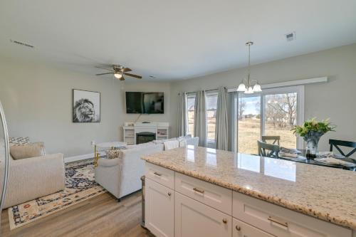 a kitchen and living room with a large counter top at Stay and Play Spacious Concord Townhome Near Uptown in Concord