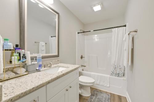 a bathroom with a sink and a toilet and a mirror at Stay and Play Spacious Concord Townhome Near Uptown in Concord