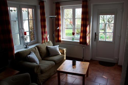 a living room with a couch and a coffee table at Ferienwohnung "Möwennest" in Hinrichsdorf