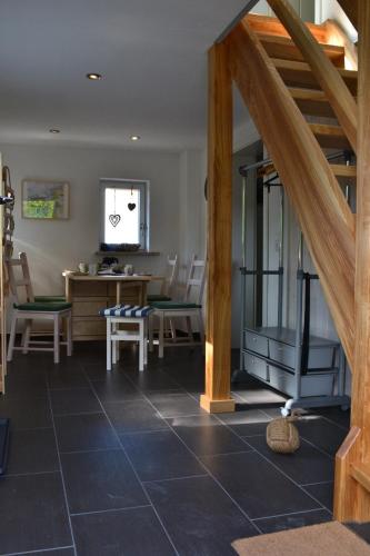 a living room with a staircase and a table and chairs at Feriendomizil "Anker" H 2 in Trent