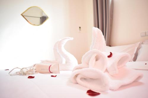 a bed with two swans made out of towels at Maison Marrakech in Touggana