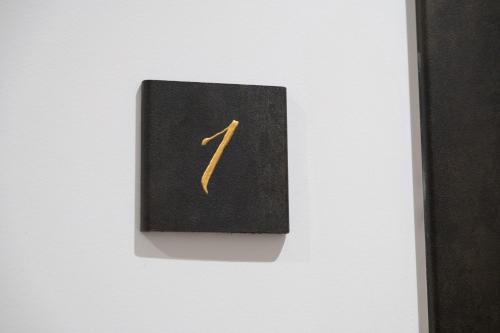 a blackswitch with a yellow arrow on a white wall at CHD Rooms in Ancona