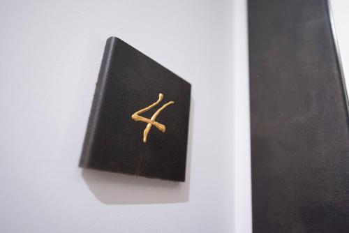 a black book with a gold symbol on it at CHD Rooms in Ancona