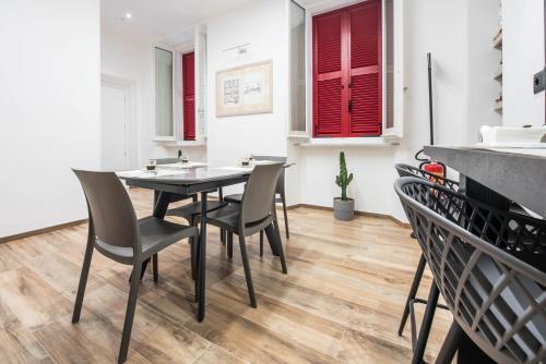 a dining room with a table and chairs at CHD Rooms in Ancona