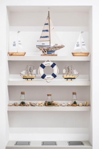 a shelf filled with different types of boats at CHD Rooms in Ancona