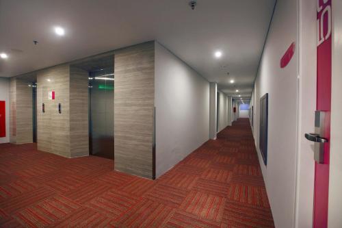 a hallway of an office building with a long corridor at favehotel Pekanbaru in Pekanbaru