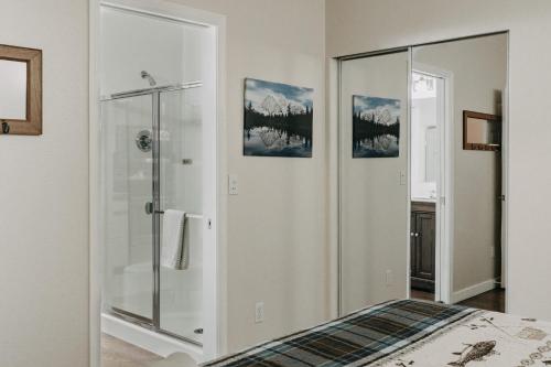 a bathroom with a shower and a glass shower stall at Glacier Springs Cabin #16 - Hot Tub - Wi-Fi in Glacier