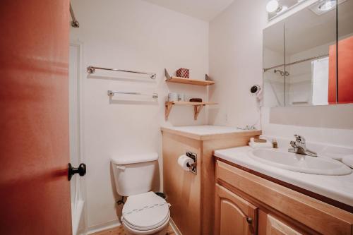 a bathroom with a toilet and a sink at Snowline Lodge Condo 18 - Beautifully Remodeled! in Glacier