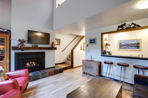 a living room with a fireplace and a red couch at Snowater Condo 6 - Fireplace - Kitchen - Sleeps 5 in Glacier