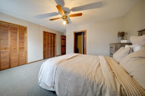 a bedroom with a bed with a ceiling fan at Fire Pit and Game Room North East Family Retreat! in North East