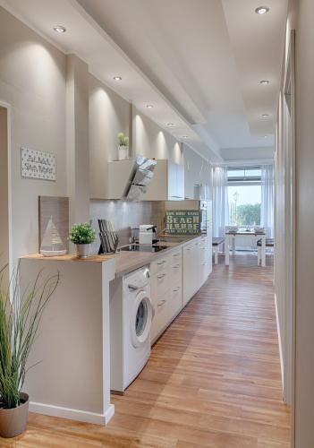 a kitchen with a washer and dryer at Strandburg Aquamarin in Burgtiefe auf Fehmarn 