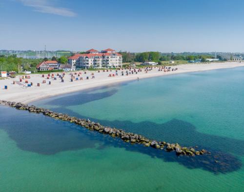 an aerial view of a beach with people in the water at Strandburg Aquamarin in Burgtiefe auf Fehmarn 