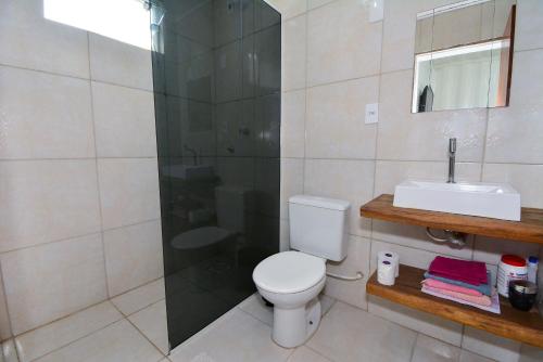 a bathroom with a shower and a toilet and a sink at Contêiner Exclusivo - Praia da Gamboa - GAR002 in Gamboa