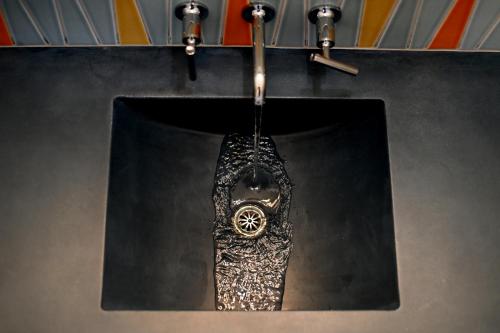 a watch hanging from a chain on a wall at The Astro in Santa Rosa