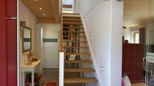 a staircase in a home with white walls and wooden ceilings at Ferienhaus Casa Rosa - LienzOsttirol in Leisach