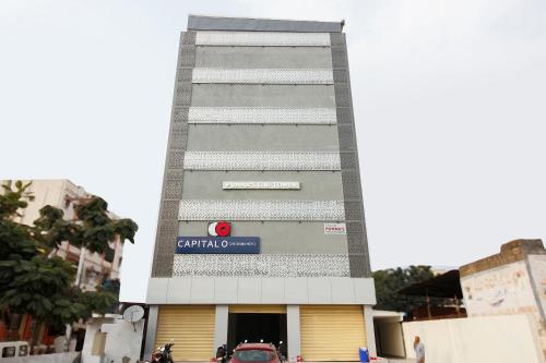 a building with a sign on the side of it at Capital O Che Sigma Hotel in Hyderabad