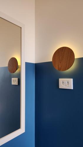a mirror in a room with a blue wall at Morada City Hostel in Sao Paulo
